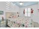 Coastal style bedroom decorated with flamingo accents and ceiling fan at 410 Georgia Ave, Crystal Beach, FL 34681