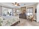 Bright bedroom features a ceiling fan, dresser, shutters, and a view of the outdoor living space at 410 Georgia Ave, Crystal Beach, FL 34681