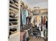Walk-in closet with custom shelving providing storage for clothes, shoes, and accessories at 410 Georgia Ave, Crystal Beach, FL 34681