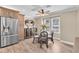 Charming dining area with natural light, wood flooring, and modern appliances at 410 Georgia Ave, Crystal Beach, FL 34681