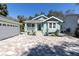 Beautiful exterior view of this light blue home with a covered porch and manicured landscaping at 410 Georgia Ave, Crystal Beach, FL 34681