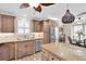 Bright kitchen with stainless appliances, granite countertops, and wooden cabinetry at 410 Georgia Ave, Crystal Beach, FL 34681