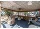 Covered poolside lounge area with comfortable chairs, a fan, and views of the backyard at 410 Georgia Ave, Crystal Beach, FL 34681