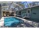 Inviting screened pool with a covered lounge area and direct access to the house, perfect for relaxation at 410 Georgia Ave, Crystal Beach, FL 34681