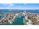 Aerial view showcasing a waterfront community with a bridge and a marina with docked boats at 436 3Rd N Ave, Tierra Verde, FL 33715