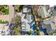 An aerial shot showcases a backyard featuring a pool, basketball court, and lush landscaping in a residential setting at 436 3Rd N Ave, Tierra Verde, FL 33715