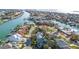 Aerial view of residential neighborhood lined with palm trees and lush landscaping along a canal at 436 3Rd N Ave, Tierra Verde, FL 33715