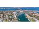 Aerial view showcasing a waterfront community with a bridge and a marina with yachts at 436 3Rd N Ave, Tierra Verde, FL 33715