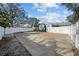Full basketball court with surrounding white fence offering a place for fun and exercise in the backyard at 436 3Rd N Ave, Tierra Verde, FL 33715