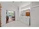 Bright bathroom boasts a double sink vanity, white cabinetry, and a serene view into the main bedroom and pool at 436 3Rd N Ave, Tierra Verde, FL 33715