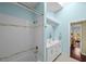 Stylish bathroom featuring a shower/tub combination and a double sink vanity with a view to an adjacent bedroom at 436 3Rd N Ave, Tierra Verde, FL 33715