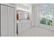 A bright bathroom featuring a vanity with double sinks and plenty of storage space at 436 3Rd N Ave, Tierra Verde, FL 33715