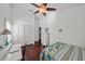 Bright bedroom featuring a ceiling fan, wood floors, a bed and a work desk at 436 3Rd N Ave, Tierra Verde, FL 33715