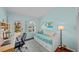 Bright bedroom featuring a daybed, desk, and outdoor access, all complemented by the room's light blue walls at 436 3Rd N Ave, Tierra Verde, FL 33715