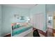 Stylish bedroom featuring a daybed, closet with bi-fold doors and a view to an adjacent bathroom at 436 3Rd N Ave, Tierra Verde, FL 33715