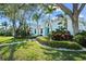 Charming two-story home with lush landscaping, mature trees, and a well-manicured lawn at 436 3Rd N Ave, Tierra Verde, FL 33715