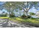 Charming two-story home with mature trees, lush landscaping, and a well-manicured lawn at 436 3Rd N Ave, Tierra Verde, FL 33715