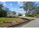 View of the property showing the expansive side yard and brick driveway with a privacy fence at 436 3Rd N Ave, Tierra Verde, FL 33715