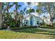 Charming light blue single-Gathering home with a well-manicured front lawn, beautiful landscaping, and mature trees at 436 3Rd N Ave, Tierra Verde, FL 33715