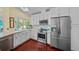 Modern kitchen with stainless appliances, white cabinets, and a farm sink at 436 3Rd N Ave, Tierra Verde, FL 33715