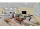 Open-concept living room with a kitchen, comfortable seating, and ample natural light at 436 3Rd N Ave, Tierra Verde, FL 33715