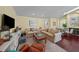 Cozy living room with hardwood floors, comfortable seating, and a decorative fireplace at 436 3Rd N Ave, Tierra Verde, FL 33715