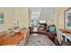 Open-concept living room with hardwood floors, decorative rug, and a view into the entryway at 436 3Rd N Ave, Tierra Verde, FL 33715