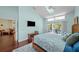 The main bedroom has a ceiling fan, wood floors, exterior access, and light blue walls at 436 3Rd N Ave, Tierra Verde, FL 33715