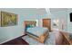 The main bedroom features wood floors, access to a second room, and natural lighting at 436 3Rd N Ave, Tierra Verde, FL 33715