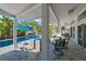Covered patio and outdoor seating area with a view of the sparkling pool at 436 3Rd N Ave, Tierra Verde, FL 33715
