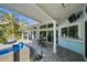 Spacious covered patio with tile flooring, outdoor seating, and convenient access to the pool area at 436 3Rd N Ave, Tierra Verde, FL 33715