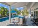Outdoor seating area with covered patio and view of the sparkling pool at 436 3Rd N Ave, Tierra Verde, FL 33715