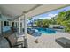 Inviting pool and spa area with lush tropical landscaping and covered patio with outdoor seating at 436 3Rd N Ave, Tierra Verde, FL 33715