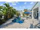 Inviting pool and spa surrounded by mature tropical plants at 436 3Rd N Ave, Tierra Verde, FL 33715