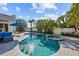 Pool and spa surrounded by lush landscaping and an elegant paver patio at 436 3Rd N Ave, Tierra Verde, FL 33715