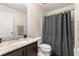 A bathroom with a granite countertop, vanity sink, and a shower at 4750 Chatterton Way, Riverview, FL 33578