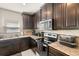 A kitchen featuring dark wood cabinets, granite countertops, and stainless steel appliances at 4750 Chatterton Way, Riverview, FL 33578