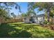 Backyard view showcasing a well-maintained lawn and a covered outdoor patio area at 4944 28Th S Ave, Gulfport, FL 33707