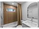 Stylish bathroom with modern vanity, shower, and wood-look tile surround at 4944 28Th S Ave, Gulfport, FL 33707