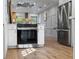Contemporary kitchen featuring white cabinets, stainless steel appliances, and wood flooring at 4944 28Th S Ave, Gulfport, FL 33707