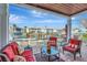 Comfortable outdoor seating area with red cushions on the patio provides a relaxing waterfront view at 5135 Coquina Key Se Dr # C, St Petersburg, FL 33705