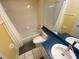 Full bathroom with shower over tub, blue countertops, and modern fixtures at 514 Cedar Woods Dr, Oldsmar, FL 34677