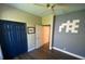 Neutral bedroom with modern ceiling fan, walk-in closet, and dark hardwood floors at 514 Cedar Woods Dr, Oldsmar, FL 34677