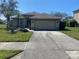 Charming single-story home with a well-maintained lawn and extended driveway at 514 Cedar Woods Dr, Oldsmar, FL 34677