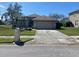Charming one-story home with a well-manicured lawn, lush landscaping, and a welcoming driveway at 514 Cedar Woods Dr, Oldsmar, FL 34677