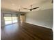 Open living room with hardwood floors and sliding glass doors to the pool at 514 Cedar Woods Dr, Oldsmar, FL 34677