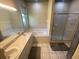 Main bathroom featuring dual sinks, large mirror, a soaking tub, and a glass-enclosed shower at 514 Cedar Woods Dr, Oldsmar, FL 34677