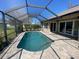 Beautiful backyard pool featuring screened-in enclosure, and a brick paver deck at 514 Cedar Woods Dr, Oldsmar, FL 34677