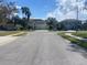 Street view, showcasing the neighborhood and surrounding homes in a residential area at 514 Cedar Woods Dr, Oldsmar, FL 34677