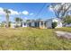 Large backyard featuring white fencing, covered patio, and mature trees at 5881 31St N Ave, St Petersburg, FL 33710